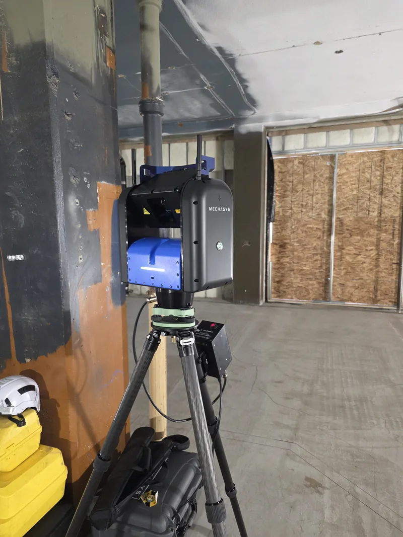 XR Projector positioned beside a concrete column on an interior fit out, ready to project layout